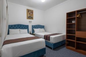 Postel nebo postele na pokoji v ubytování Hotel Rojas Inn