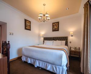 Postel nebo postele na pokoji v ubytování Hotel Rojas Inn