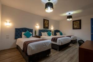 Postel nebo postele na pokoji v ubytování Hotel Rojas Inn