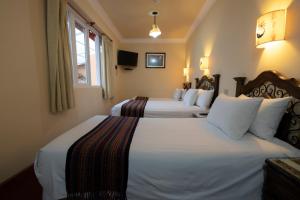 Postel nebo postele na pokoji v ubytování Hotel Rojas Inn
