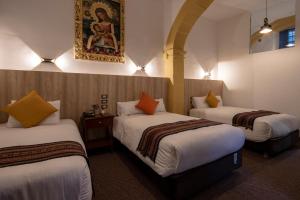 Postel nebo postele na pokoji v ubytování Hotel Rojas Inn
