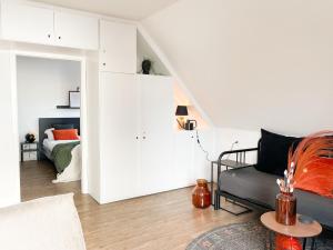 a living room with a couch and a bed at Ferienhof Bannick in Bistensee