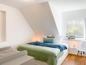 Habitación blanca con cama y ventana en Ferienhof Bannick en Bistensee