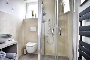 a bathroom with a shower and a toilet and a sink at MeinHaff in Ueckermünde