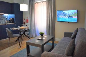 a living room with a couch and a table at Apartamentos Colmeia in Lisbon