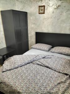 a bedroom with a large bed with a black headboard at Safir Luxury imperial 666 in Bucharest +1 photo