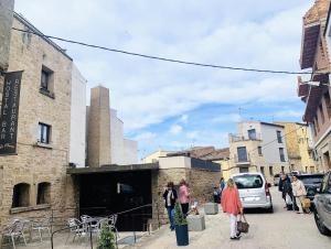 a group of people walking down a city street at Hostal La Placeta in Arbeca