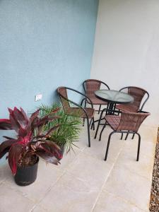 a patio with a table and chairs and a potted plant at Retreat by the Beach Lovely New 2 Bedroom in Discovery Bay