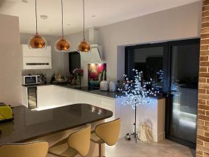 a kitchen with a counter with a christmas tree in it at Stunning 5 bed house in Surrey Minimum stay 5 nights in Sunbury