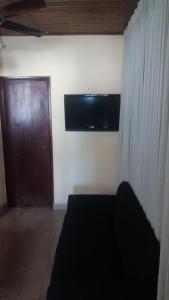 um quarto com uma porta e uma televisão na parede em reconquista em Reconquista