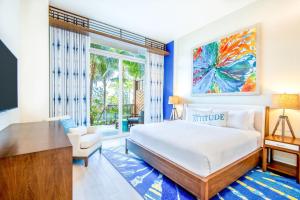 
a bedroom with a large bed and a large window at Margaritaville Beach Resort Nassau in Nassau

