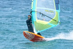 a man riding a wind sail on the water at BAJA SUITES UPSTAIRS in Punta Abreojos