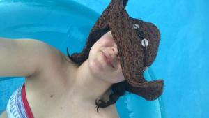 a woman wearing a hat on her head in a pool at BAJA SUITES UPSTAIRS in Punta Abreojos