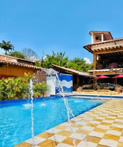 a pool of water with a swimming pool at Hotel Hicasua y Centro de Convenciones in Barichara