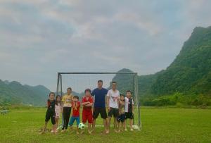 a group of people standing in front of a soccer goal at Viet Hai Lan Homestay in Cat Ba