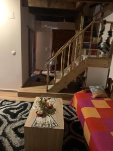 a living room with a bed and a coffee table at Μεζονέτα στους Αγίους Δέκα Κέρκυρας in Áyioi Dhéka
