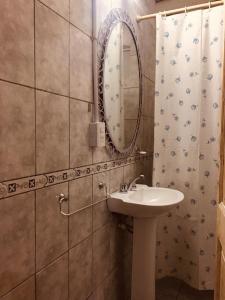 a bathroom with a sink and a mirror at Rincon La Magda in Ciudad Lujan de Cuyo