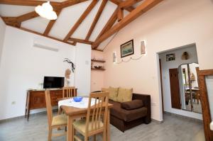 a living room with a table and a couch at House Pobri in Opatija