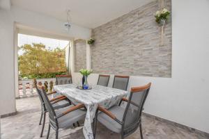 a dining room with a table and chairs at Apartment Rota in Turanj
