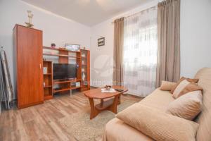 a living room with a couch and a tv at Apartment Rota in Turanj