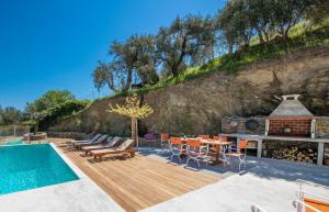 a backyard with a wooden deck and a swimming pool at Avgi Villa in Glossa
