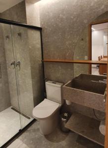 a bathroom with a toilet and a shower and a sink at SALINAS PREMIUM RESORTS in Salinópolis
