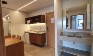 a small kitchen with a sink and a mirror at SALINAS PREMIUM RESORTS in Salinópolis