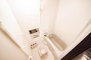 a small bathroom with a toilet and a sink at GIFT in Otaru +19 photos