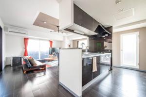 a kitchen with a large white refrigerator in a room at GLITZ in Otaru