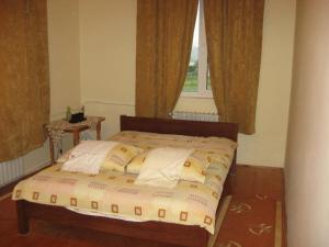a bed sitting in a bedroom with a window at Lary Hostel in Suceava