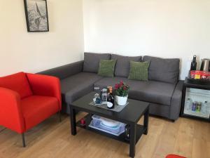 a living room with a couch and a red chair at Harmony Affittacamere in Riomaggiore +59 photos
