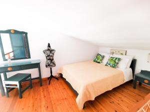 a bedroom with a bed and a desk and a mirror at Haris apartments in Koukounaries