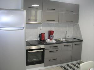 a small kitchen with a refrigerator and a sink at Sea U in Chania Town