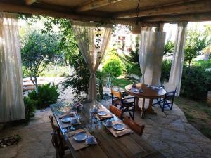 a table and chairs on a patio with a table and chairs at Idili in Panormos Rethymno