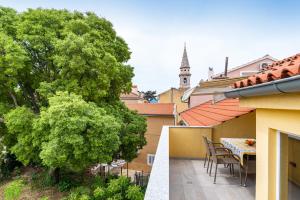 a balcony of a house with a table and chairs at IDA ARTS APARTMENTS in Zadar