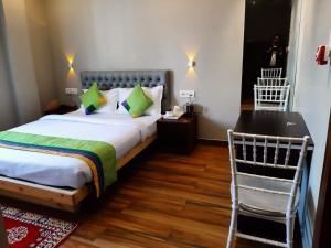 a bedroom with a bed and a desk and a chair at HOTEL MITTAL GARDEN in Siliguri +56 photos