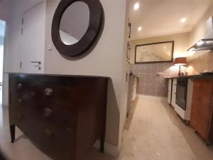 a bathroom with a dresser and a mirror on the wall at Lovely two bedroom apartment seconds from the Sea! in Sliema