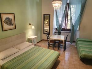 a bedroom with a bed and a table and a desk at sleep easy in Florence