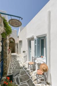 a patio with a table and chairs on a building at Venetian Suites III in Naxos Chora