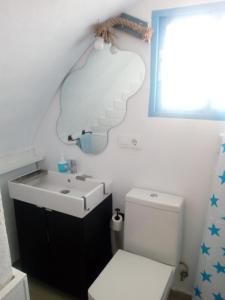 a bathroom with a sink and a toilet at El Escondite de Vejer in Vejer de la Frontera +17 photos