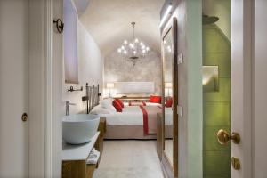 a bathroom with a bedroom with a bed and a sink at Dimora del Leone Gaeta in Gaeta