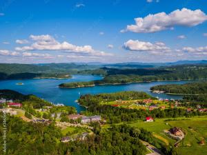 an aerial view of a town and a lake stock photo at Domki Bieszczadzki Czar Rodzinny 661-850-410 in Polańczyk