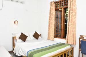Postel nebo postele na pokoji v ubytování Pearl Bungalow Trincomalee