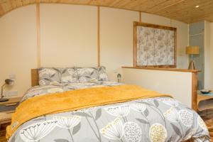 a bedroom with a bed and a picture on the wall at Fell View Park Escape Pods with hot tubs in Kirkby Lonsdale