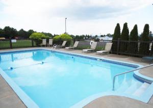 a large swimming pool with blue water at Days Inn by Wyndham Montmagny in Montmagny