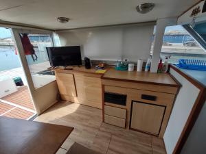 a kitchen with a desk and a tv on a boat at BED&BOAT boatandholiday in Fano