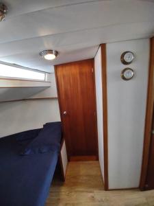 a small room with a bed and a door at BED&BOAT boatandholiday in Fano