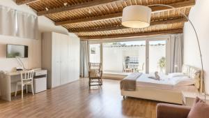 a bedroom with a bed and a desk and a table at Scicli Albergo Diffuso in Scicli