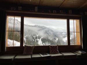 a window with a view of a mountain view at Chalet Im Wieselti in Langwies