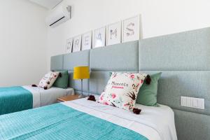 a bedroom with two beds and a headboard and a lamp at Sun&Sea Luxury Apartment by MP in Vila Nova de Gaia